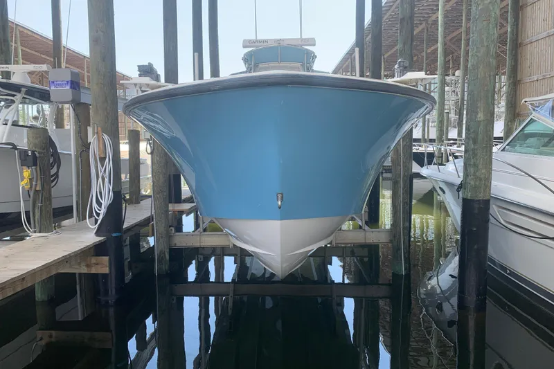 Slide: The Image of 2008 Invincible 36 CC boat docked in marina, front view. - 2