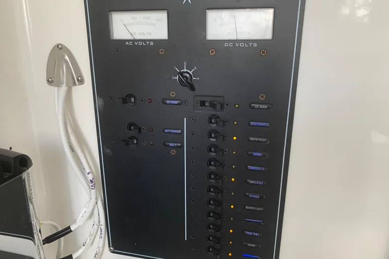 Slide: The Image of Electrical control panel on a 2008 Invincible 36 CC boat, showing AC and DC volt meters. - 22