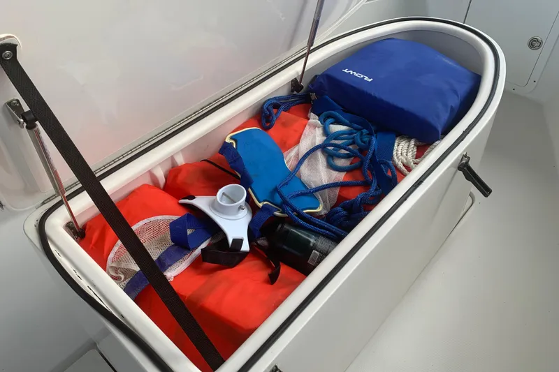 Slide: The Image of Storage compartment on 2008 Invincible 36 CC boat with safety gear and ropes. - 25