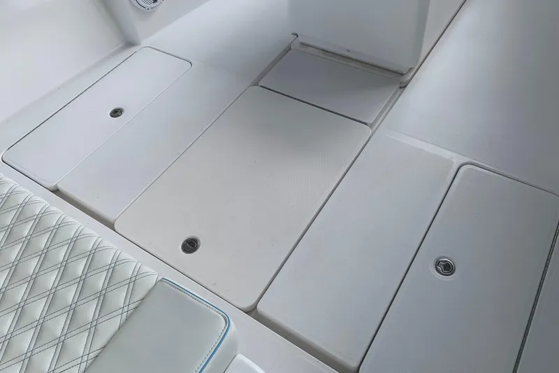 Slide: The Image of Invincible 36 CC 2008 boat deck with storage compartments and cushioned seating. - 28