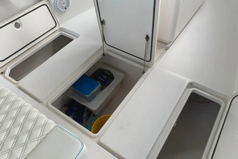 Slide: The Image of Storage compartments on a 2008 Invincible 36 CC boat, featuring organized interior space. - 29