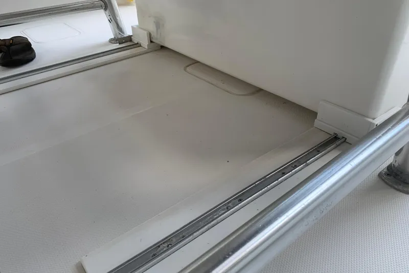 Slide: The Image of Interior view of 2008 Invincible 36 CC boat, featuring metal railings and white flooring. - 31