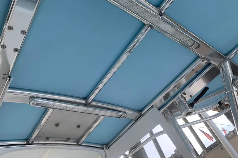 Slide: The Image of Blue canopy and metal framework of 2008 Invincible 36 CC boat. - 33