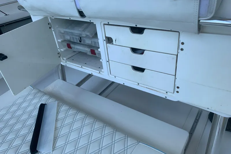 Slide: The Image of Storage compartment with drawers and tackle boxes on a 2008 Invincible 36 CC boat. - 37