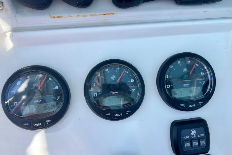 Slide: The Image of Dashboard of a 2008 Invincible 36 CC boat showing RPM gauges and controls. - 42