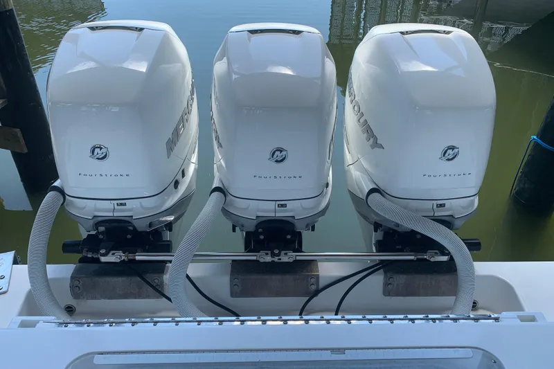 Slide: The Image of Triple Mercury FourStroke engines on a 2008 Invincible 36 CC boat. - 6