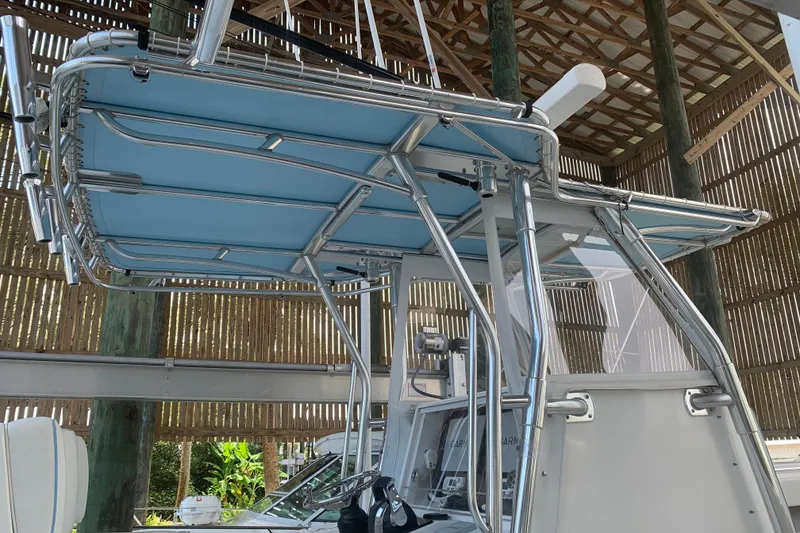 Slide: The Image of 2008 Invincible 36 CC boat with blue T-top and stainless steel frame in a boathouse. - 7