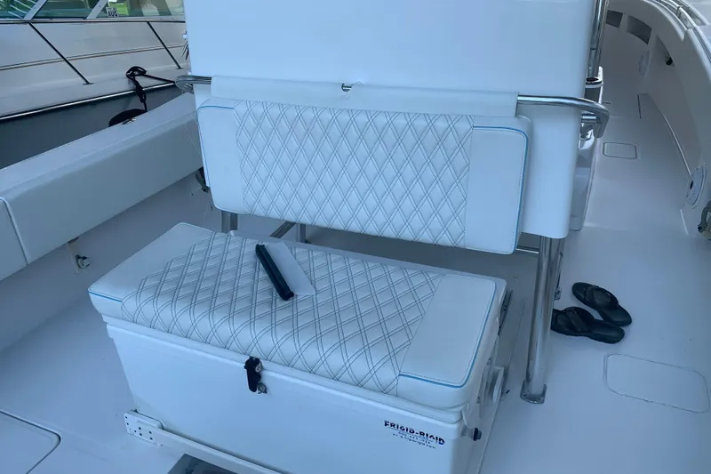 Slide: The Image of Invincible 36 CC 2008 boat interior with cushioned seating and cooler. - 8