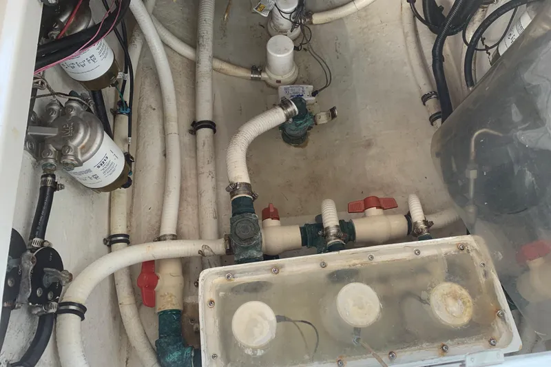 Slide: The Image of Engine compartment of a 2008 Invincible 36 CC boat, showcasing pipes and filters. - 9