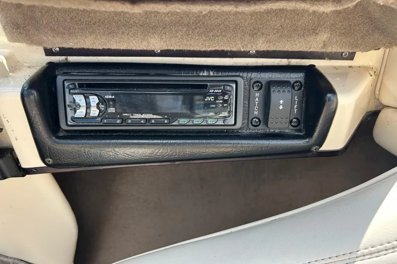Slide: The Image of 1999 Malibu Sunsetter VLX dashboard with JVC stereo and hatch lift controls. - 14