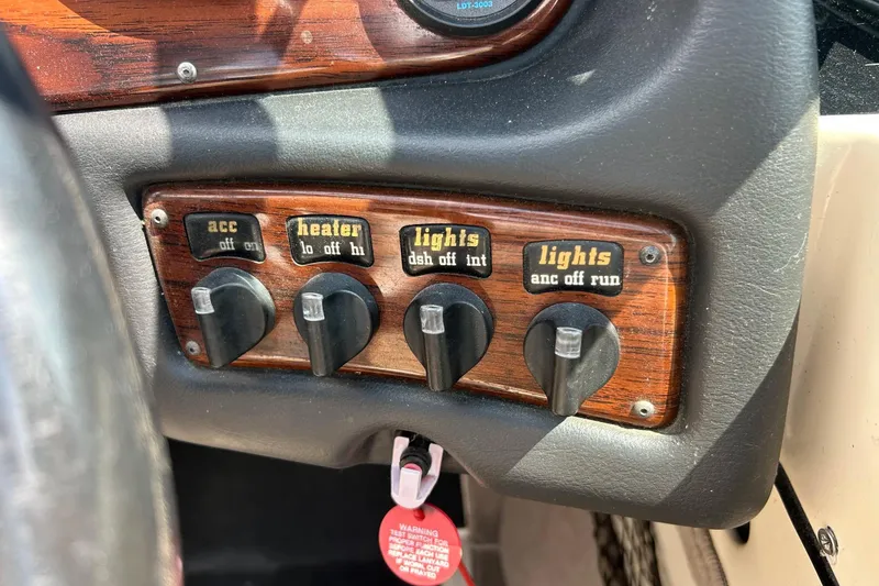 Slide: The Image of 1999 Malibu Sunsetter VLX dashboard with accessory, heater, and light controls. - 15