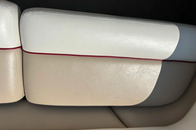Slide: The Image of 1999 Malibu Sunsetter VLX boat seat with white and beige upholstery, red trim. - 20