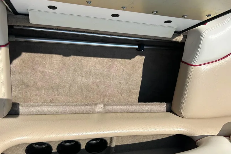 Slide: The Image of 1999 Malibu Sunsetter VLX interior with beige upholstery and carpeted flooring. - 23