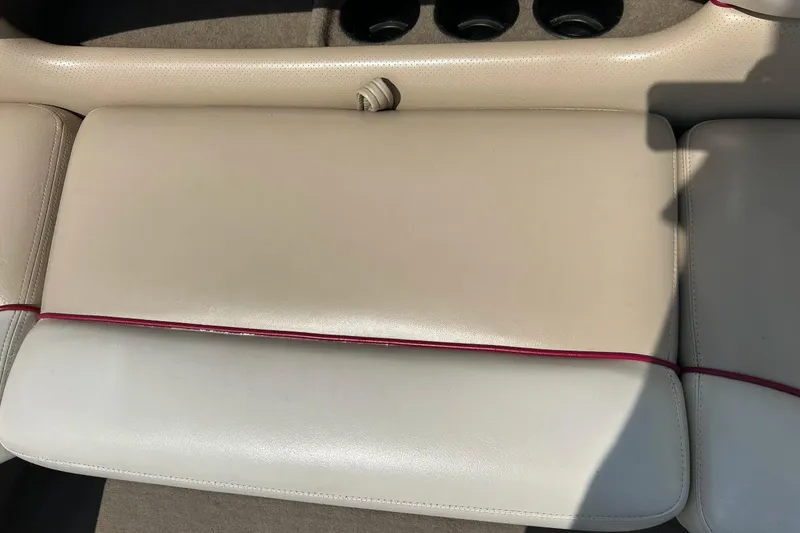 Slide: The Image of 1999 Malibu Sunsetter VLX boat interior with beige leather seats and red trim. - 24