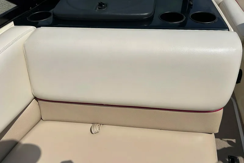 Slide: The Image of 1999 Malibu Sunsetter VLX boat interior with beige seating and cup holders. - 25