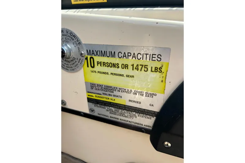 Slide: The Image of 1999 Malibu Sunsetter VLX capacity label, 10 persons or 1475 lbs, compliance details. - 30