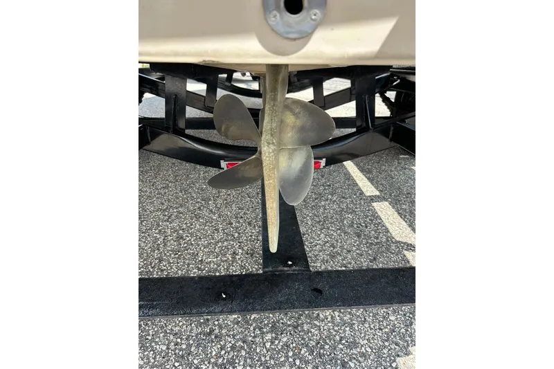 Slide: The Image of 1999 Malibu Sunsetter VLX boat propeller on a trailer, close-up view. - 31