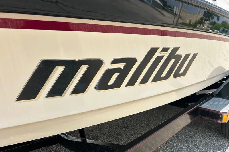 Slide: The Image of 1999 Malibu Sunsetter VLX boat with bold logo on the side. - 33