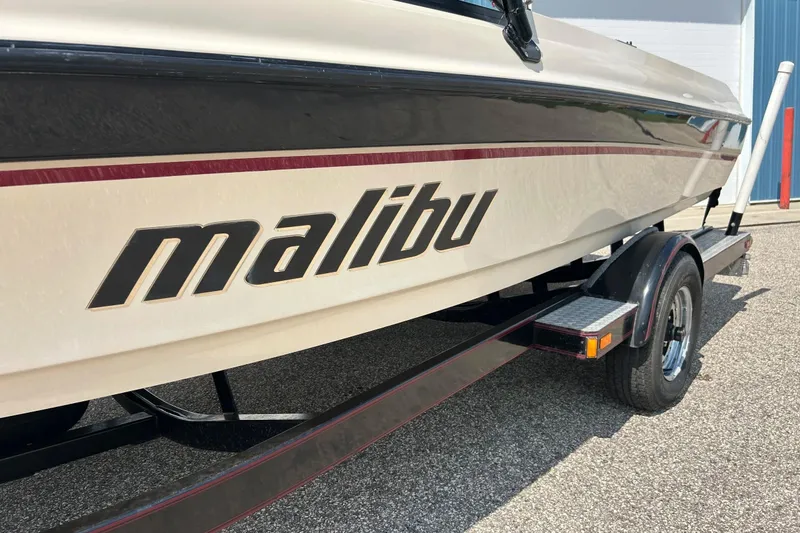 Slide: The Image of 1999 Malibu Sunsetter VLX boat on trailer, side view with logo visible. - 35
