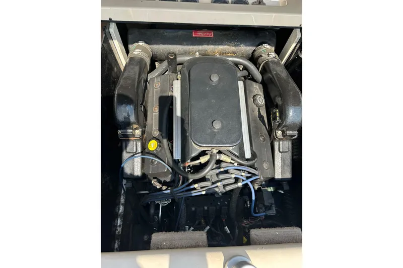 Slide: The Image of Engine of a 1999 Malibu Sunsetter VLX boat, showcasing intricate components. - 38