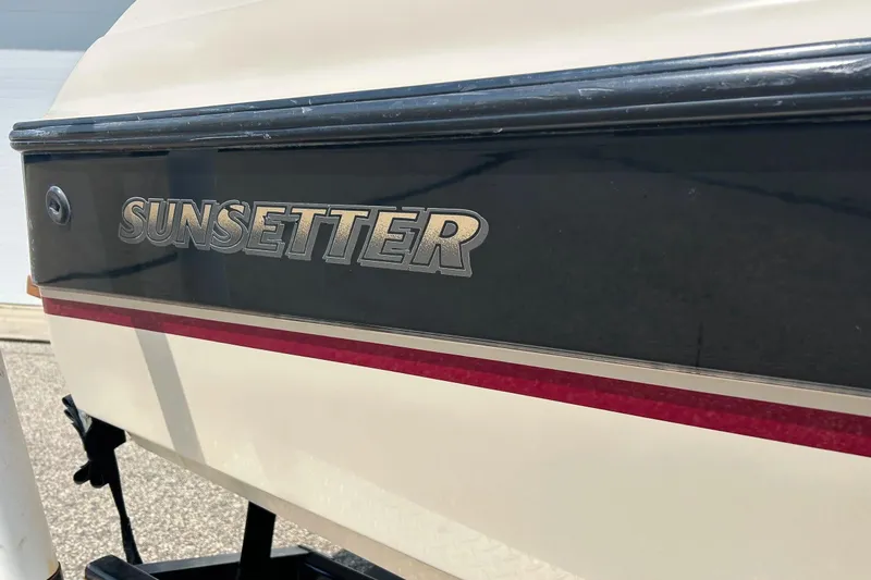 Slide: The Image of 1999 Malibu Sunsetter VLX boat with logo detail and red stripe. - 4