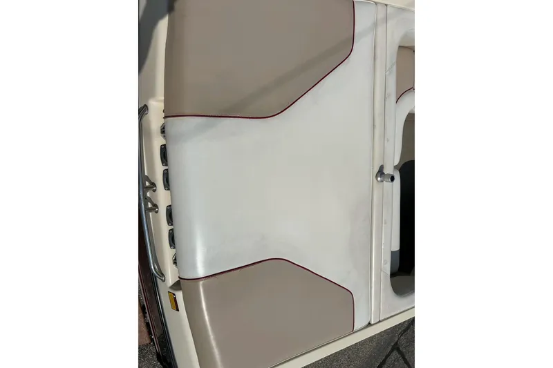 Slide: The Image of 1999 Malibu Sunsetter VLX boat interior with beige and white upholstery. - 6