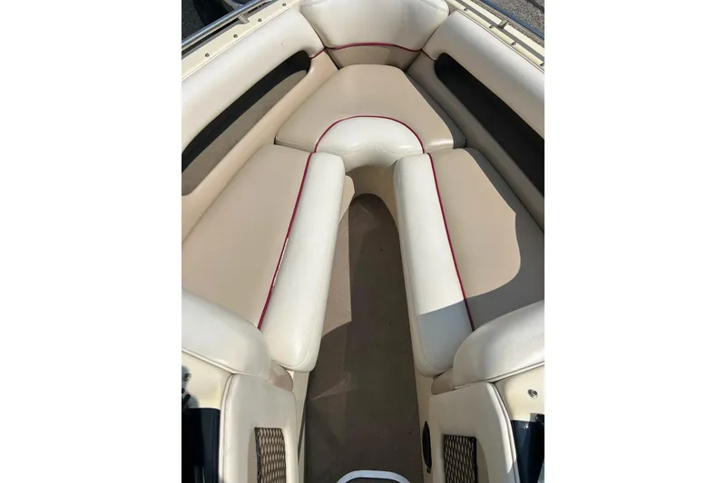 Slide: The Image of 1999 Malibu Sunsetter VLX boat interior with beige seating and red accents. - 7