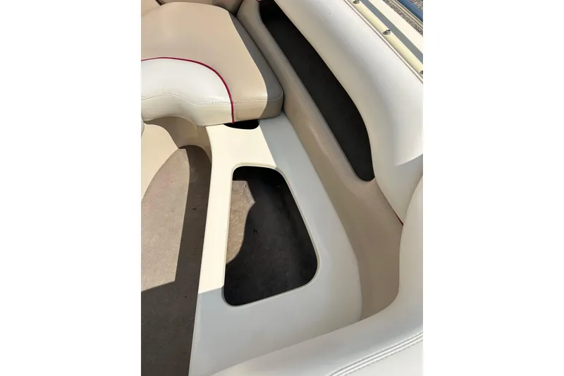 Slide: The Image of 1999 Malibu Sunsetter VLX boat interior with beige and white seating. - 9