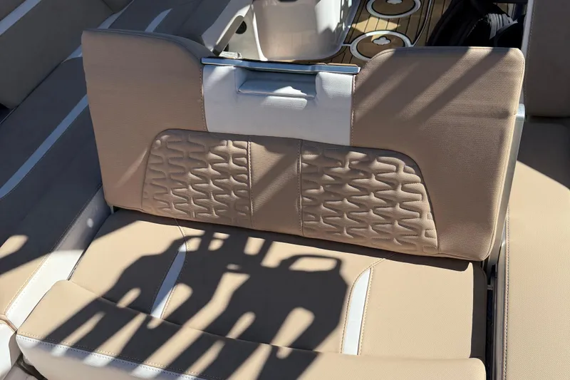 Slide: The Image of 2025 MasterCraft X24 boat interior with beige and white cushioned seating. - 10