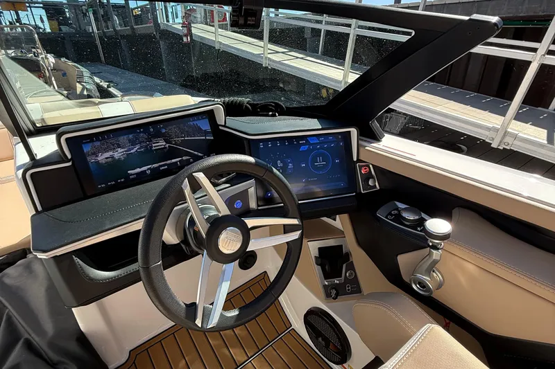 Slide: The Image of 2025 MasterCraft X24 boat dashboard with modern touchscreen controls and sleek steering wheel. - 12