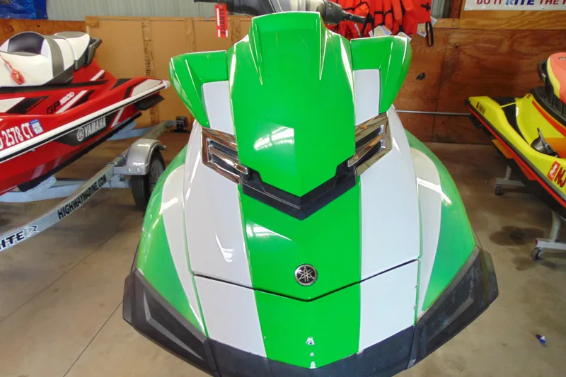 Slide: The Image of 2014 Yamaha WaveRunner FX HO in green and white, parked indoors. - 3