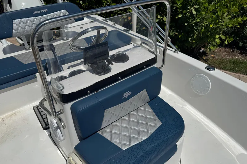Slide: The Image of 2019 Sea Pro 172 Bay boat interior with blue and silver seating and steering console. - 3