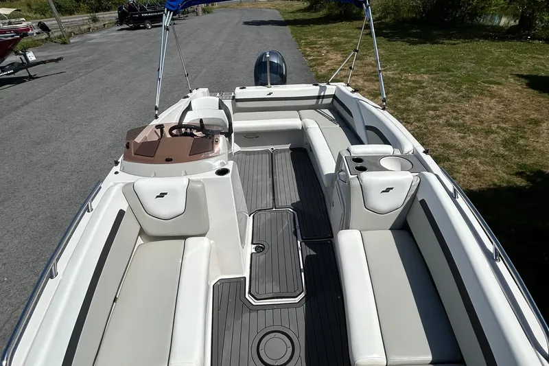 Slide: The Image of 2021 Starcraft SVX 191 OB boat interior with white seating and gray flooring. - 2