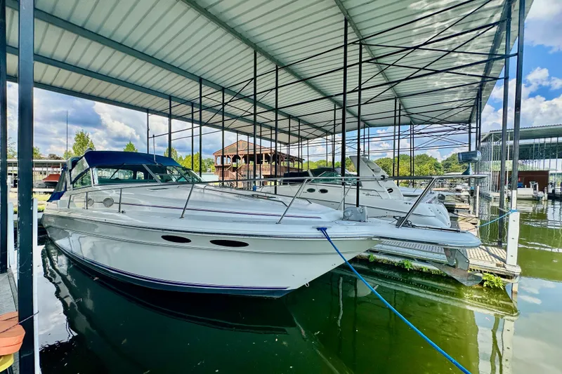 Slide: The Image of 1994 Sea Ray 330 Sundancer docked under covered marina. - 1
