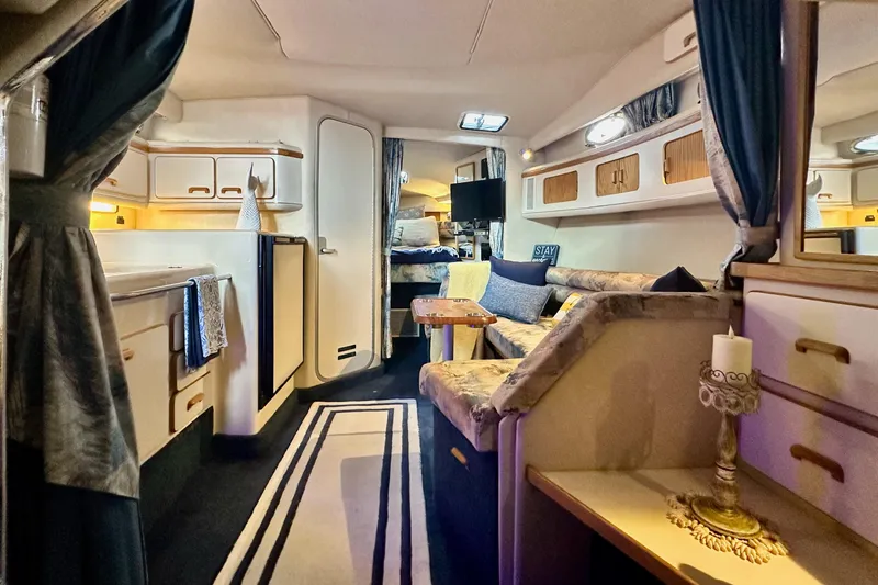 Slide: The Image of Interior of a 1994 Sea Ray 330 Sundancer yacht, featuring cozy seating and elegant decor. - 12