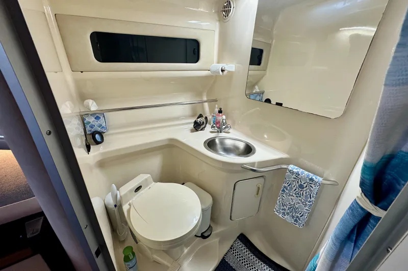 Slide: The Image of 1994 Sea Ray 330 Sundancer bathroom with sink, toilet, and mirror. - 14