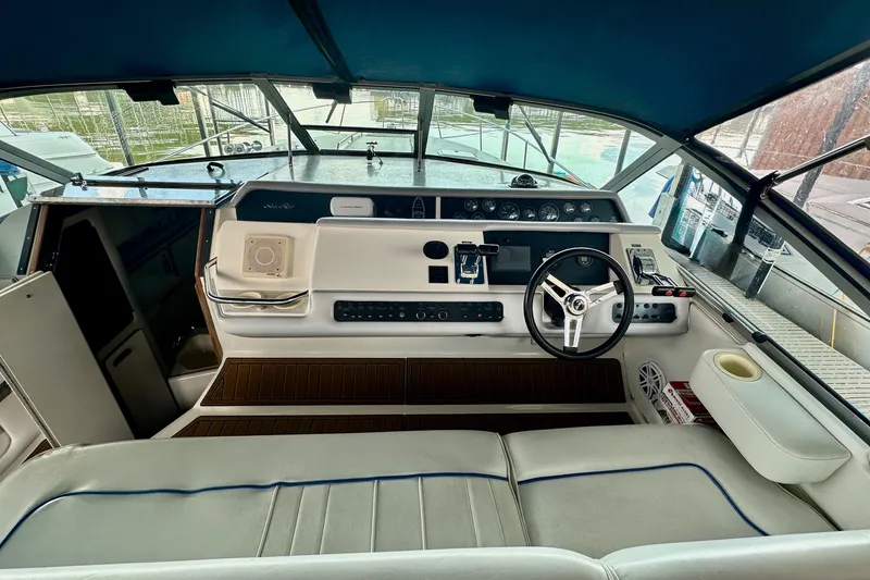 Slide: The Image of Interior view of 1994 Sea Ray 330 Sundancer boat cockpit with steering wheel and controls. - 15