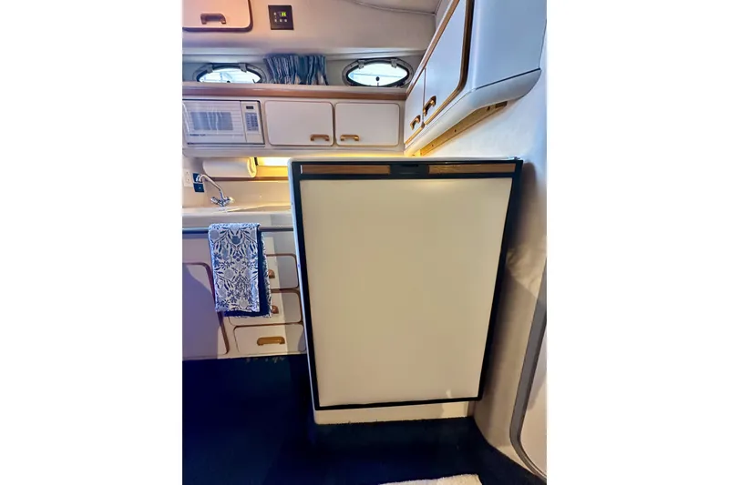 Slide: The Image of Interior of 1994 Sea Ray 330 Sundancer showing kitchenette with fridge and microwave. - 7