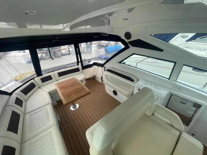 Slide: The Image of Luxurious interior of 2018 Beneteau Gran Turismo 40 yacht with elegant seating and wooden table. - 15