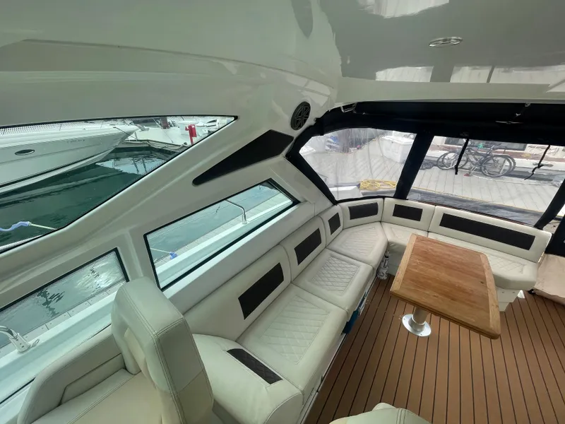 Slide: The Image of Interior of 2018 Beneteau Gran Turismo 40 yacht with elegant seating and wooden table. - 16