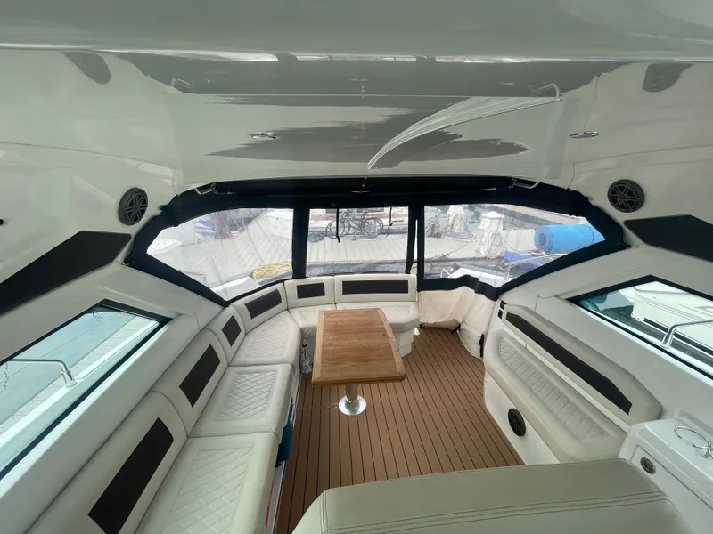 Slide: The Image of Interior of 2018 Beneteau Gran Turismo 40 yacht with elegant seating and wooden table. - 17