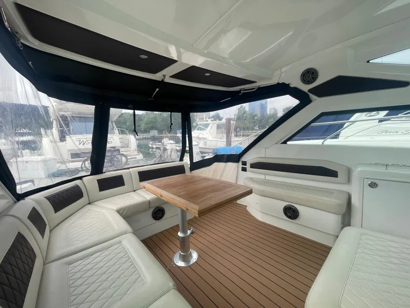 Slide: The Image of Interior of 2018 Beneteau Gran Turismo 40 yacht with elegant seating and wooden table. - 19