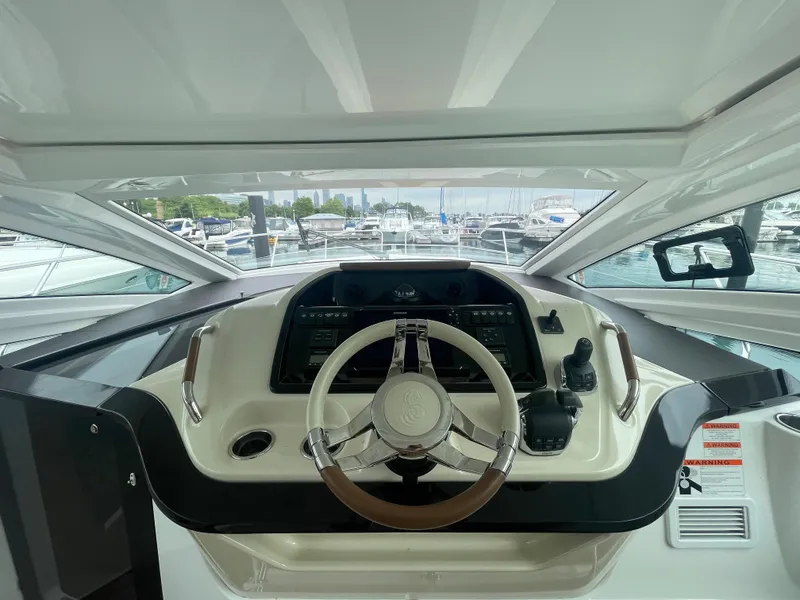 Slide: The Image of Beneteau Gran Turismo 40 helm, 2018 model, with marina view in background. - 24