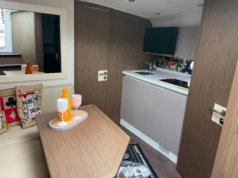 Slide: The Image of Interior of 2018 Beneteau Gran Turismo 40 yacht with modern kitchen and cozy seating area. - 25
