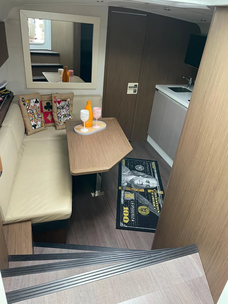 Slide: The Image of 2018 Beneteau Gran Turismo 40 interior with cozy seating and modern kitchenette. - 26