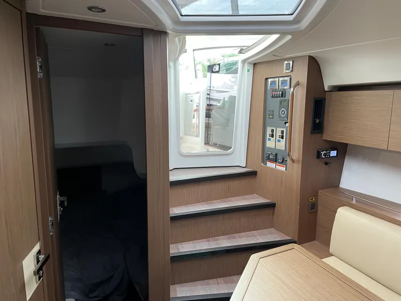 Slide: The Image of Interior of 2018 Beneteau Gran Turismo 40 yacht with wooden stairs and control panel. - 28