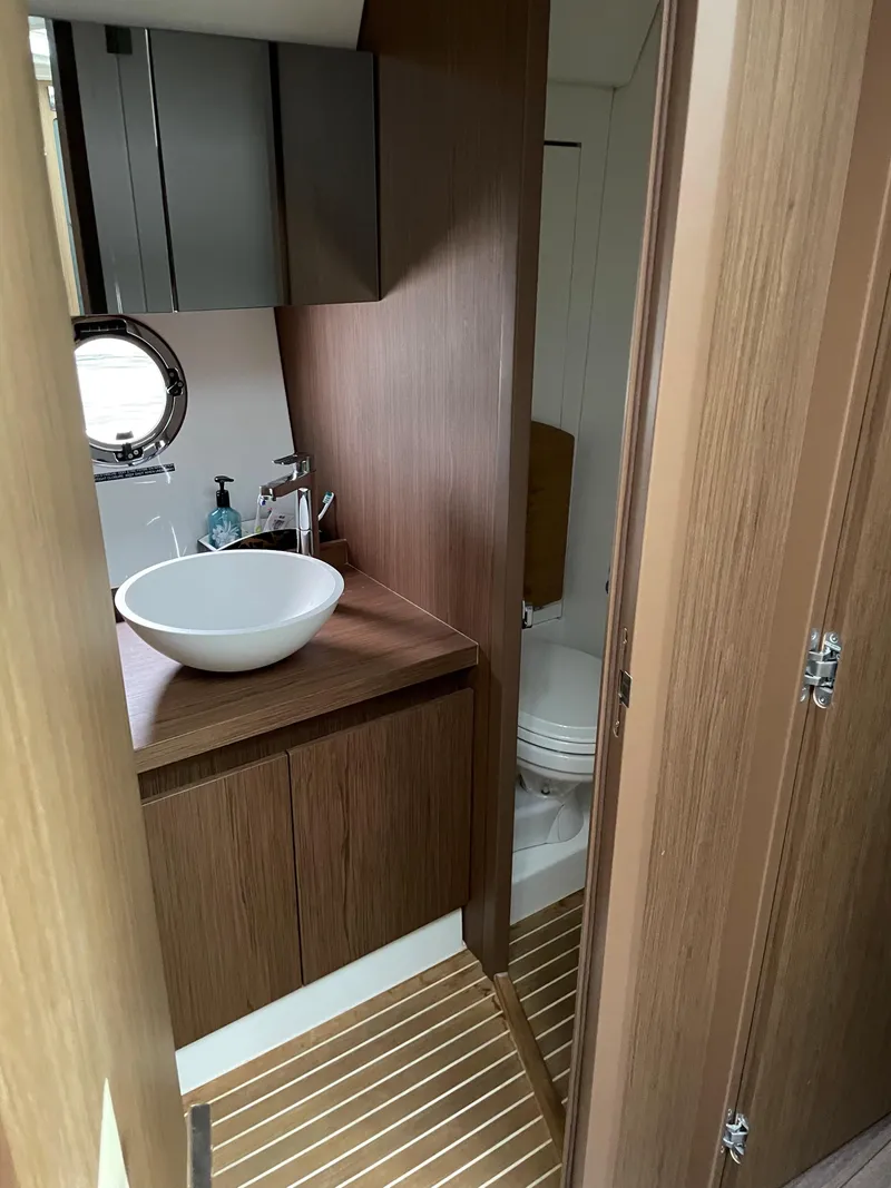 Slide: The Image of 2018 Beneteau Gran Turismo 40 yacht bathroom with modern sink and wooden cabinetry. - 30