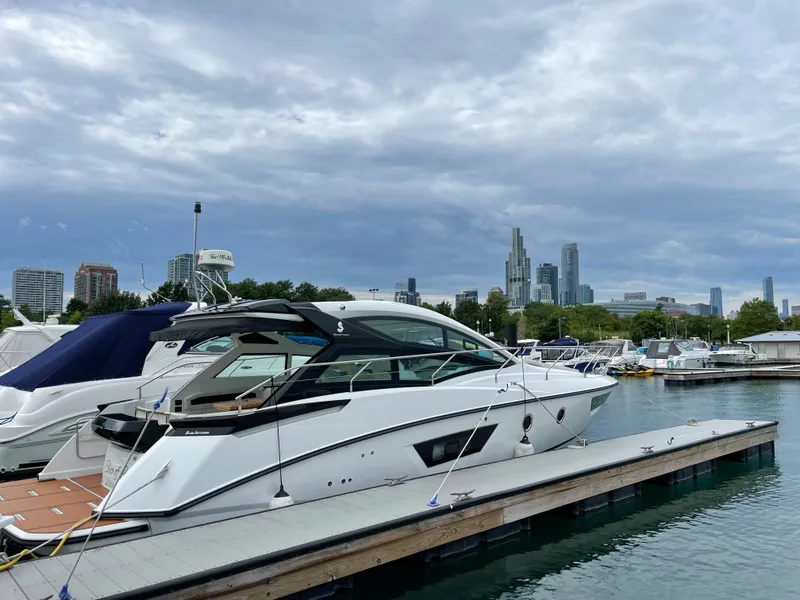 Slide: The Image of 2018 Beneteau Gran Turismo 40 yacht docked in marina with city skyline. - 31