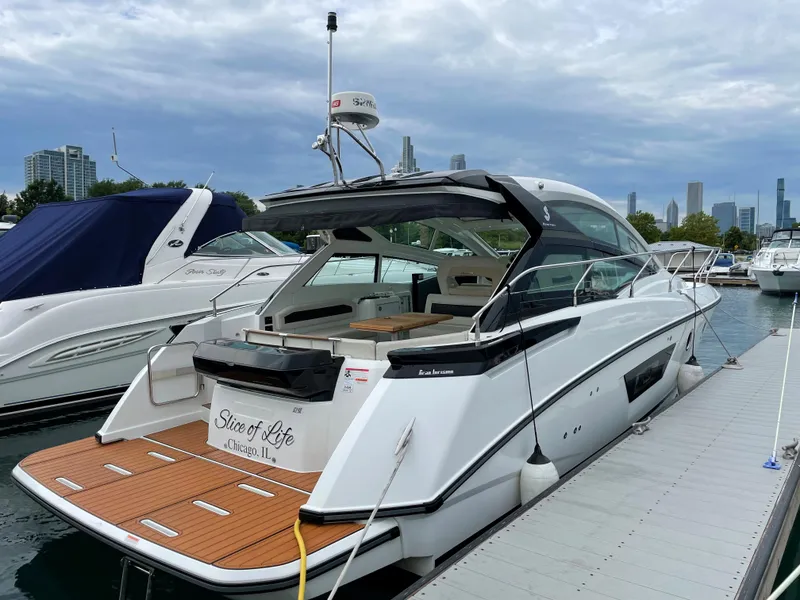 Slide: The Image of 2018 Beneteau Gran Turismo 40 yacht docked at marina, city skyline in background. - 8