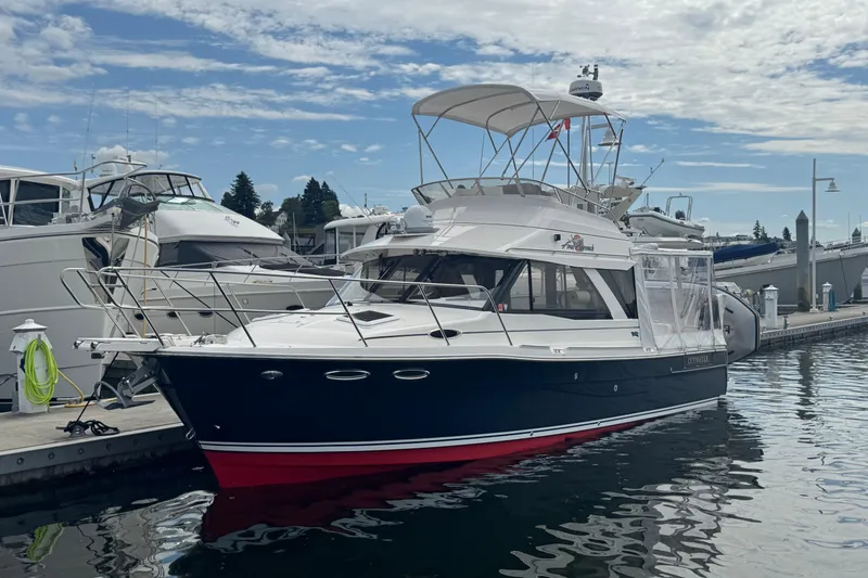 The Image of 2020 Cutwater C-30 CB boat docked at marina under a partly cloudy sky. - 0